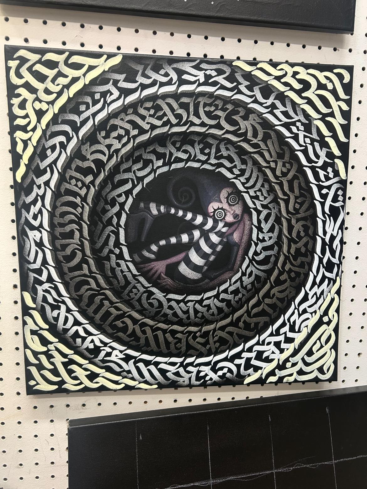 Calligraffiti spiral with snake motif on dark background